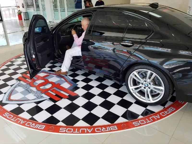 Printed floor graphic around a car at a dealership