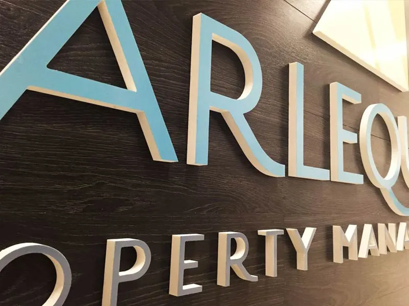 Harlequin Property Management dimensional lettering on wood
