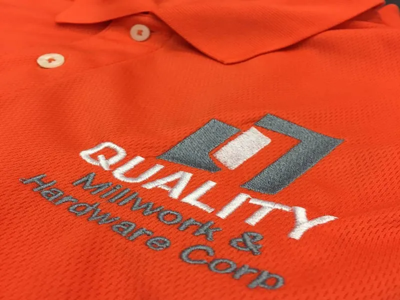 Embroidered logo on an orange polo shirt