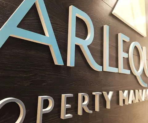Harlequin Property Management dimensional lettering on wood