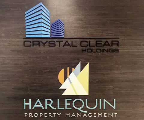 Crystal Clear Holdings and Harlequin Property Management lobby signs