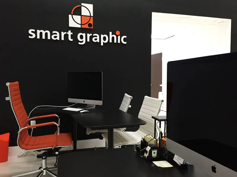 Smart Graphic reception desk with the logo on a black wall